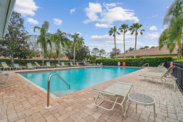 community pool featuring a patio area and fence