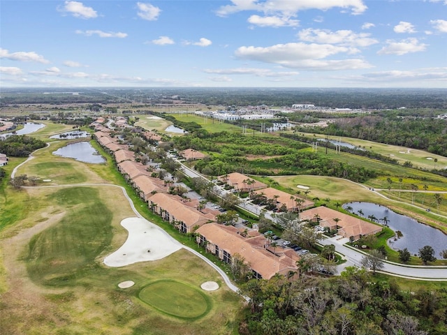 drone / aerial view with view of golf course and a water view