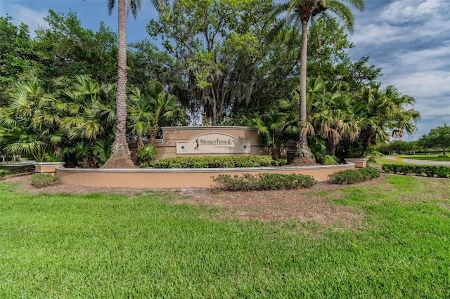 community / neighborhood sign with a lawn