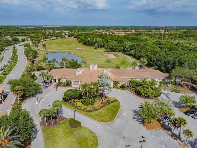 bird's eye view featuring a forest view, golf course view, and a water view