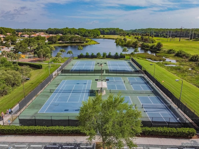 view of sport court featuring a water view and fence