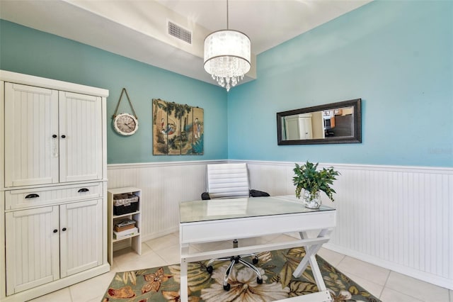 office space featuring a chandelier, wainscoting, visible vents, and light tile patterned floors