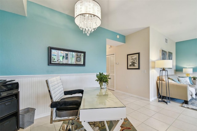 office space with an inviting chandelier, light tile patterned floors, visible vents, and a wainscoted wall