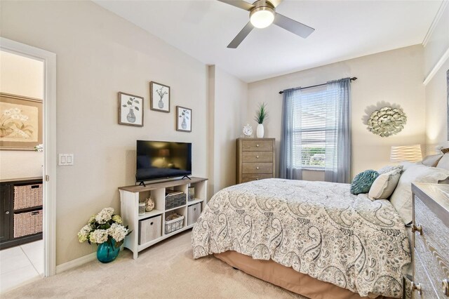 carpeted bedroom with ceiling fan and baseboards