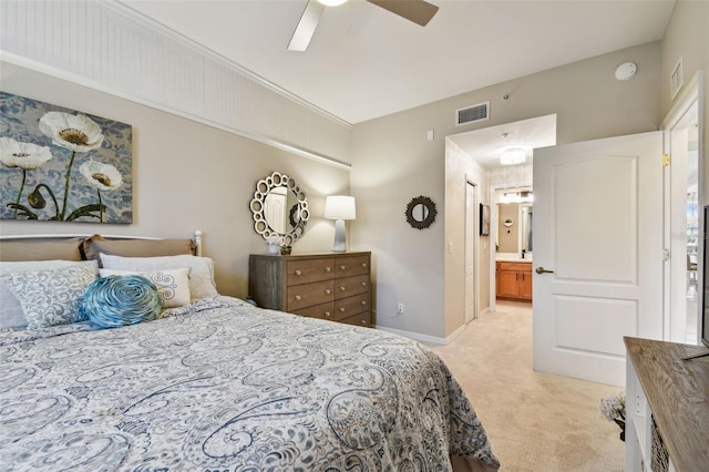 bedroom with light carpet, ensuite bath, visible vents, and baseboards