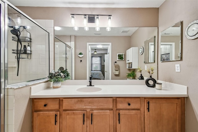 full bathroom with a ceiling fan, connected bathroom, a shower stall, and vanity