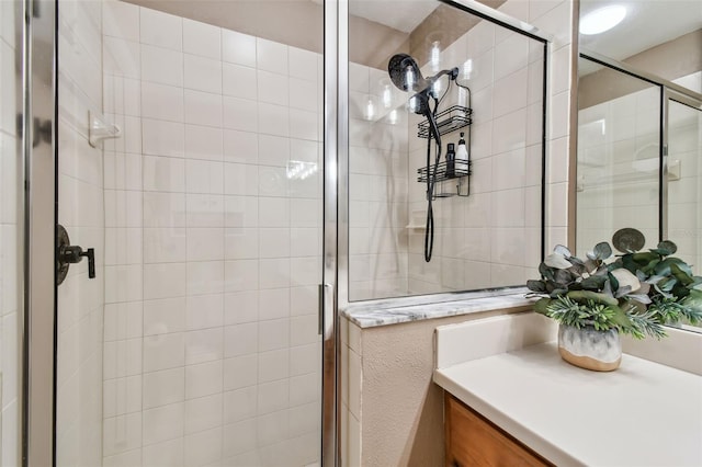 full bathroom with a stall shower and vanity