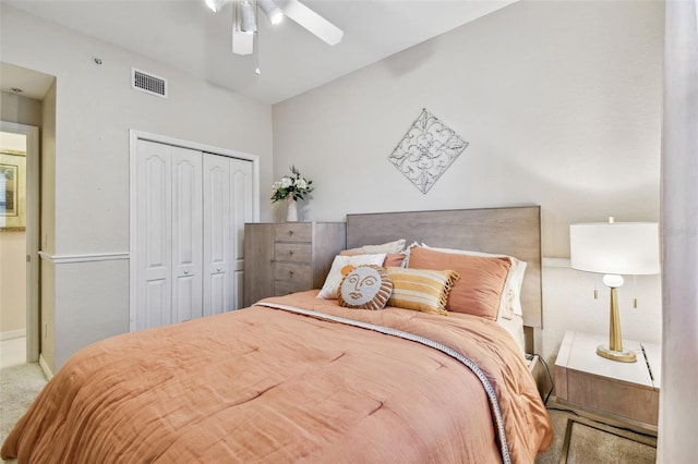 carpeted bedroom with a ceiling fan, visible vents, and a closet