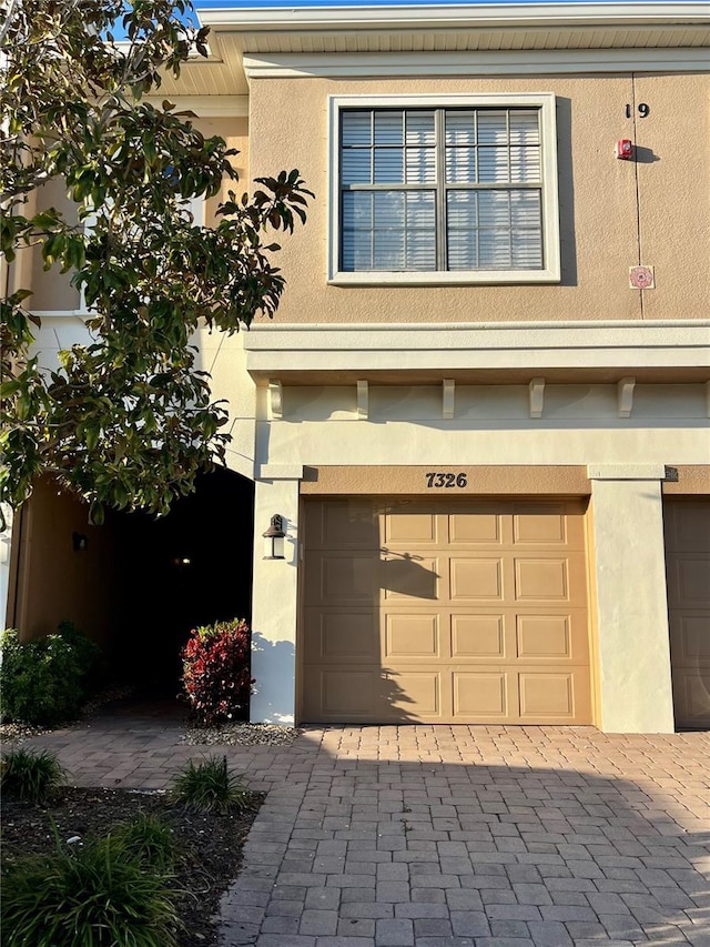 garage with decorative driveway