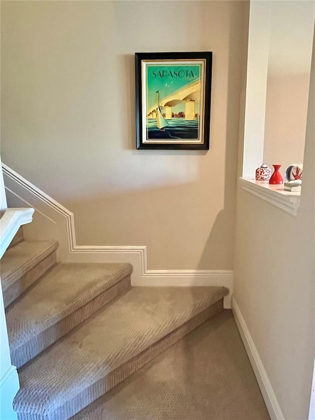 stairway with carpet flooring and baseboards