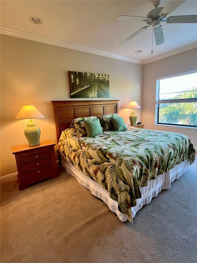 bedroom with ceiling fan, carpet floors, and crown molding