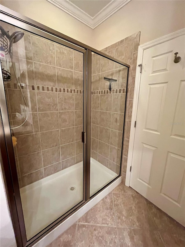 full bathroom with a stall shower, tile patterned flooring, and ornamental molding