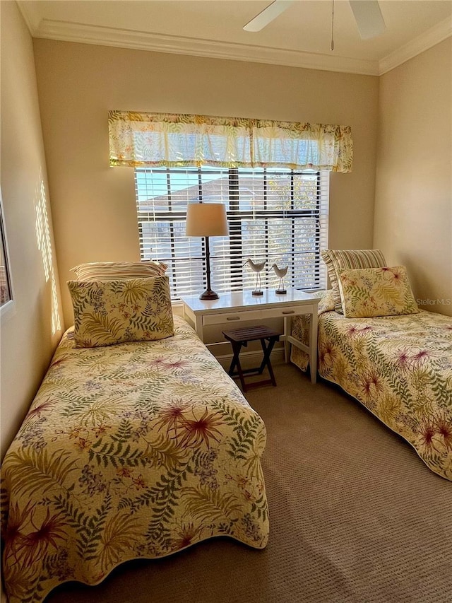 carpeted bedroom featuring ornamental molding and a ceiling fan