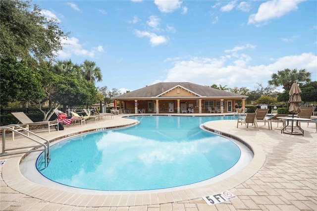 community pool with a patio area