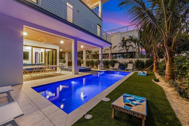 view of pool with a fenced in pool, a lawn, a patio area, fence, and an in ground hot tub