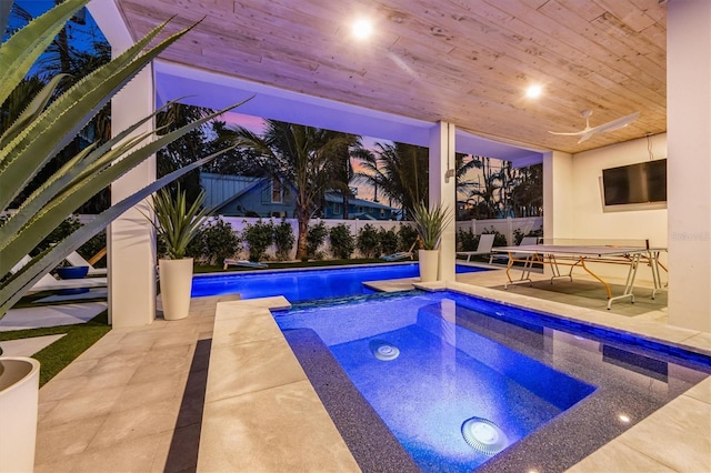 view of pool featuring ceiling fan, an in ground hot tub, a patio area, and a fenced backyard