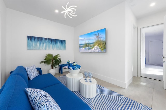 living area with a chandelier, recessed lighting, and baseboards