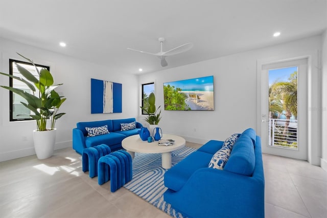 living area with a ceiling fan, recessed lighting, and baseboards