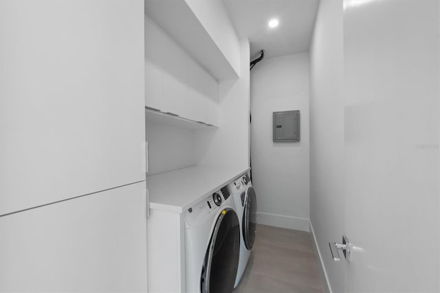 clothes washing area featuring laundry area, electric panel, baseboards, washing machine and clothes dryer, and recessed lighting