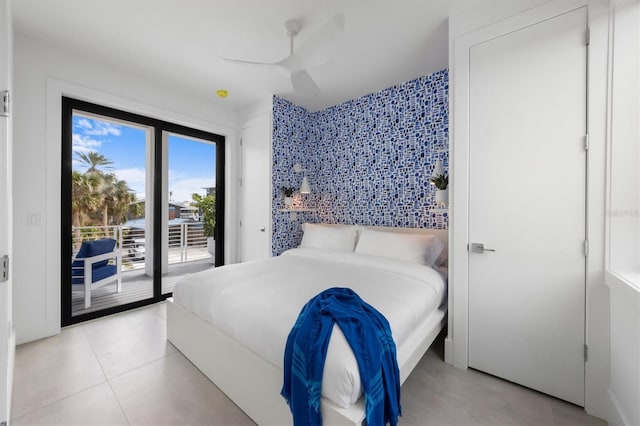 bedroom featuring access to exterior, ceiling fan, and light tile patterned flooring