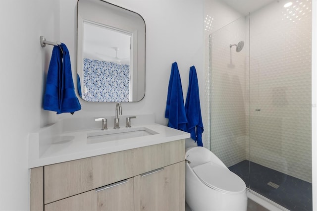 bathroom featuring a stall shower, vanity, and toilet