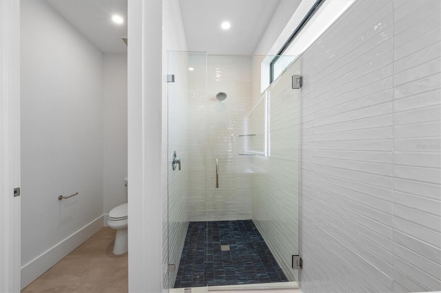 bathroom featuring toilet, a shower stall, baseboards, and recessed lighting