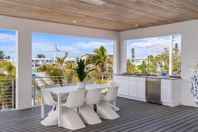 deck featuring outdoor dining area, a sink, and area for grilling