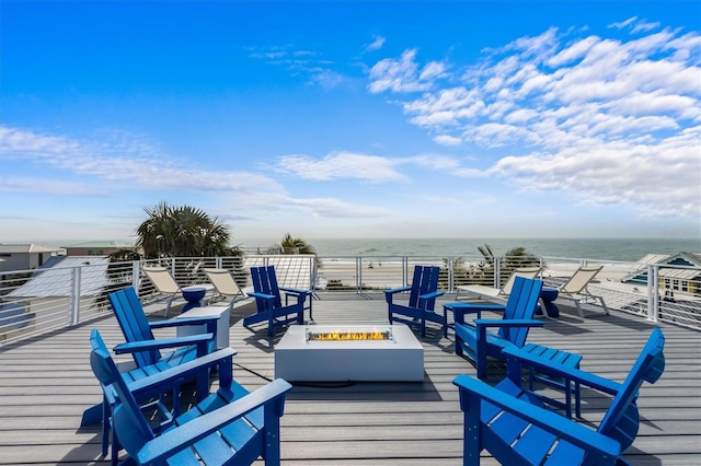 deck featuring a water view and an outdoor fire pit