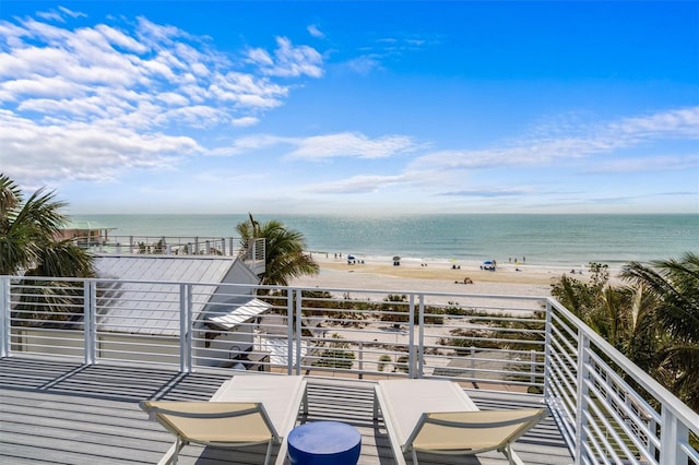 balcony featuring a water view and a beach view