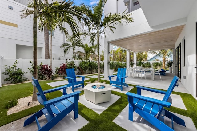 view of patio featuring a fire pit and fence