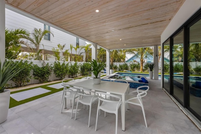 view of patio with a fenced in pool, outdoor dining space, and a fenced backyard