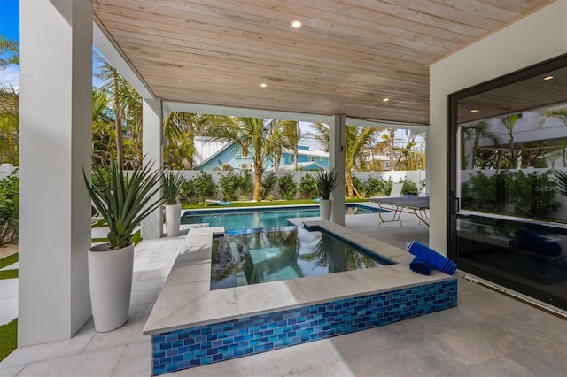 view of swimming pool featuring a fenced in pool, a fenced backyard, and a patio