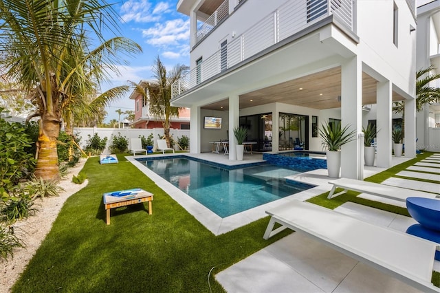 view of swimming pool with a lawn, a patio, a fenced in pool, an in ground hot tub, and fence