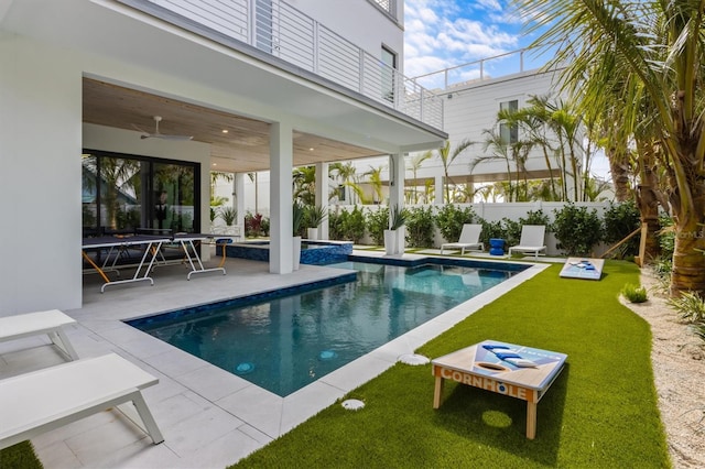 view of pool featuring a fenced in pool, a yard, a ceiling fan, a patio area, and fence