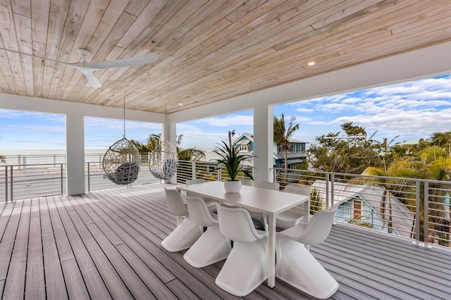 deck with outdoor dining area and ceiling fan