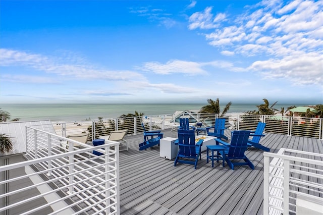 deck with a view of the beach and a water view