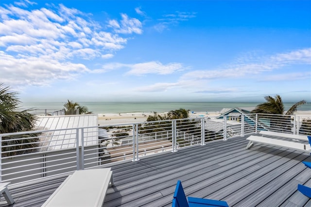 wooden terrace with a water view and a view of the beach