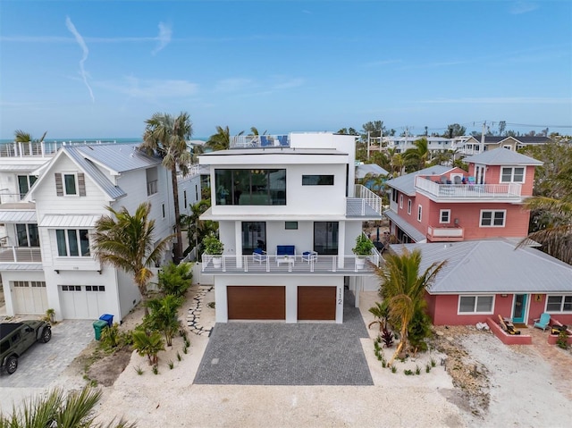 view of front of property with a residential view, driveway, a balcony, and an attached garage