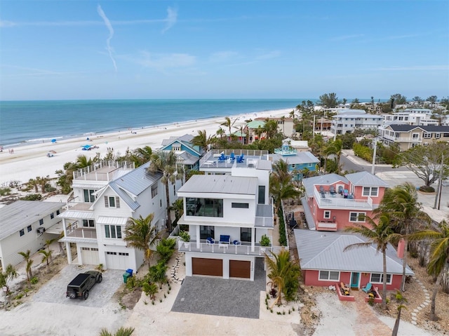 birds eye view of property with a beach view, a residential view, and a water view