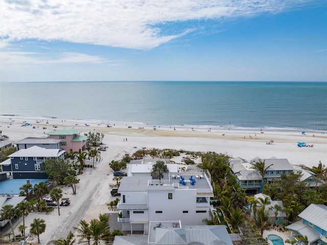 drone / aerial view featuring a water view and a view of the beach