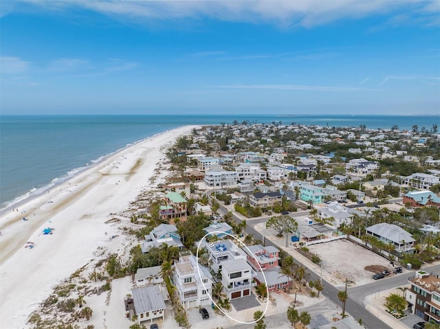 birds eye view of property with a beach view and a water view