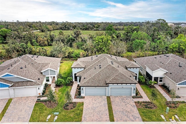 drone / aerial view with a forest view and a residential view