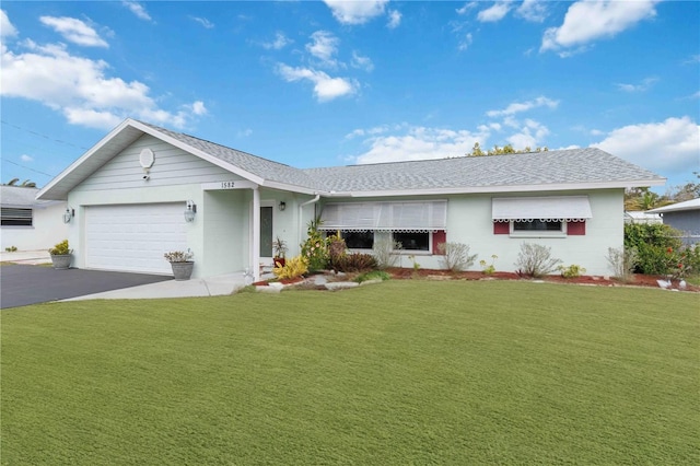 ranch-style house featuring a garage, driveway, a shingled roof, and a front yard