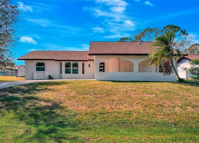 single story home with fence, a front lawn, and stucco siding