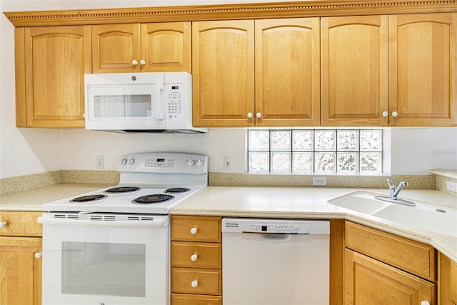 kitchen featuring light countertops, white appliances, and a sink