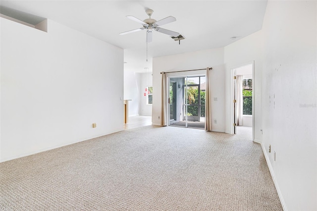 carpeted empty room with baseboards and a ceiling fan