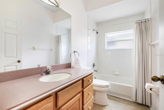 bathroom with shower / tub combo, vanity, toilet, and wood finished floors