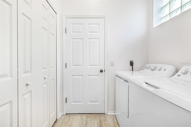 laundry room featuring washer and dryer, laundry area, and light wood finished floors