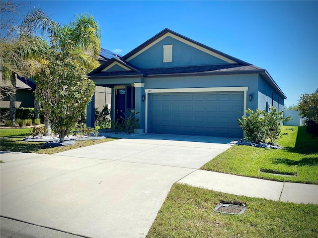 single story home with driveway, an attached garage, a front yard, and stucco siding