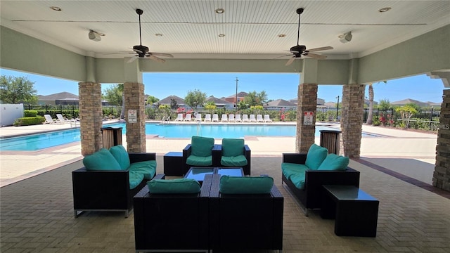 view of patio / terrace featuring fence, an outdoor living space, and a community pool